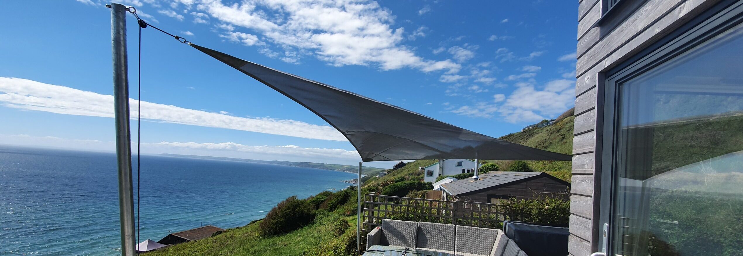 Sail Shades Christmas: Sail Shade installation looking over the ocean
